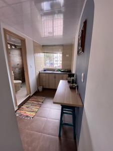 a kitchen with a wooden table and a counter top at Hotel Boutique Casa Magaly in Bogotá