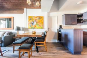 a kitchen and dining room with a table and chairs at Résidence Les Arcs 1950 Le Village - maeva Home - Appartement 3 pièces 6 personnes vue sur le Mont Blanc - Prestige - super Home MAE-4490 in Bourg-Saint-Maurice