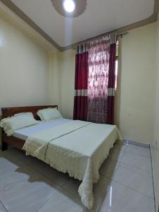 a bedroom with a bed and a window at URBAN VIBER MOTEL in Kigali