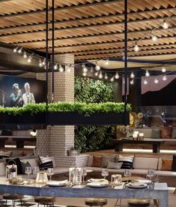 a restaurant with a table and chairs and a tv at Estudio en Estoril cercano a principales centros de ski in Santiago