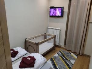 a bedroom with two beds and a tv on the wall at ToTi Kalman in Zlatibor +22 photos