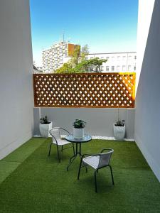 um pátio com uma mesa e cadeiras numa varanda em Affordable Luxury Apartment em Gqeberha