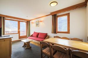 a living room with a red couch and a table at Résidence Les Valmonts - maeva Home - Appartement 3 Pièces 6 Personnes - Confort MAE-2689 in Saint-Martin-de-Belleville