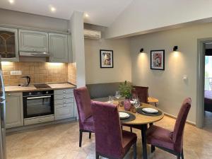 a kitchen and dining room with a table and chairs at Villa Risan Apartments in Risan