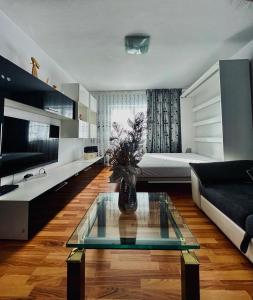 una sala de estar con un sofá y una mesa en Apartament ASK HOME, en Slănic-Moldova