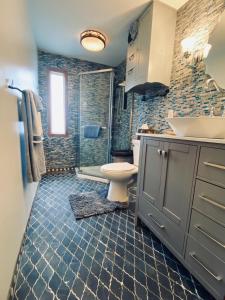 a bathroom with a toilet and a sink and a shower at The Farmhouse ranch in Stockton +32 photos