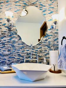 a bathroom with a sink and a mirror at The Farmhouse ranch in Stockton