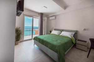 a bedroom with a bed with a view of the ocean at BLU MARINE in Catanzaro