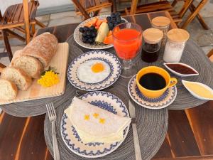 a table with eggs and bread and a cup of coffee at Mara Jeri Pousada in Jericoacoara