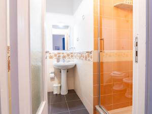 a bathroom with a sink and a toilet at ARIA DI MARE ROOMS in Cefalù +32 photos
