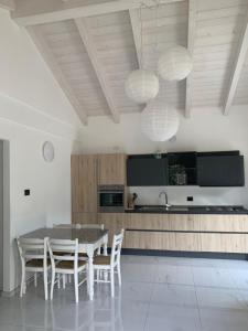 a kitchen with a table and chairs in a room at Oasi verde in Aosta