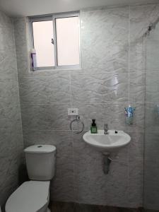 uma casa de banho com um WC e um lavatório em Apartamento Flandes em Flandes