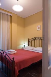 een slaapkamer met een groot bed en een rode deken bij Orsiida sea view apartment Agria in Agria