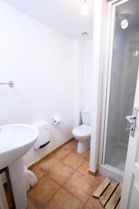 a bathroom with a toilet and a sink and a shower at Les Chalets Petit Bonheur - LES CHALETS PETIT BONHEUR - CHT93 MAE-2484 in Villarodin-Bourget