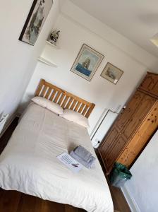 a bedroom with a white bed with two pillows at The OX1 in Oxford