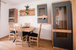 a dining room with a table and chairs and a kitchen at Apartment Jazz in Požega