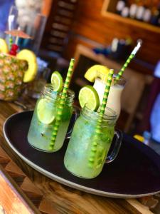 two mason jars with lime slices on a plate at Hotel Isla del Sol in Isla Grande