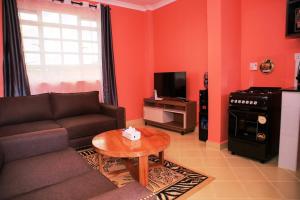 a living room with a couch and a table at Todas Hotel in Kiambu