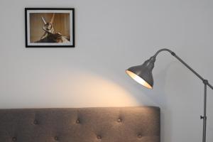 a lamp and a couch with a picture on the wall at Unique and luxury city center apartment with free parking in Southampton