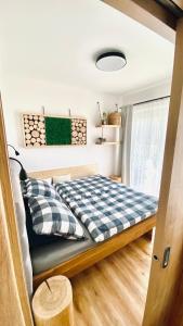 a bedroom with a bed in a tiny house at Apartmán Lipenka in Černá v Pošumaví