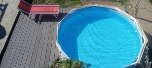 an overhead view of a large blue pool on a deck at Casa La Românaș in Tuzla