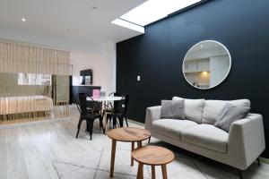 a living room with a couch and a table at Primera Parada By Wynwood House in Lima