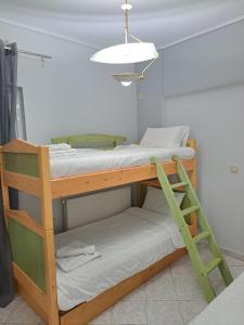 a bunk bed in a room with a light at Four seasons apartment in Artemida