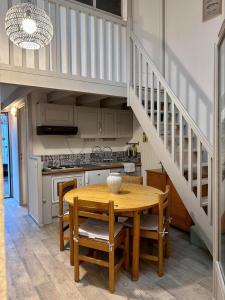 a kitchen with a wooden table and a staircase at Bright house with terrace and garden in Camiers