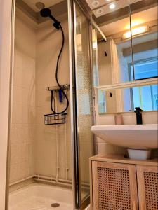 a bathroom with a shower and a sink at Bright house with terrace and garden in Camiers +4 photos