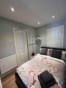 a bedroom with a large bed with flowers on it at Guest Suite Enfield in Enfield