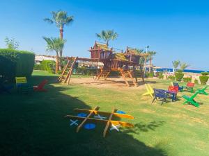 a playground with colorful chairs and a play structure at Tamra Residence Apartment Families and Couples Only in Sharm El Sheikh