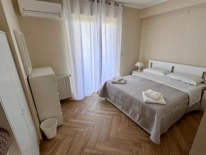 a bedroom with a bed with two towels on it at Columbia House in Palmi +10 photos