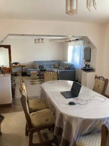 a living room with a table with a laptop on it at Trai bun in Maramures in Fereşti +17 photos