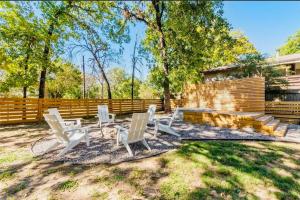 a group of white chairs sitting in a yard at The Hickory House with Firepit- Boat Ramp Access to Cedar Creek Lake in Tool