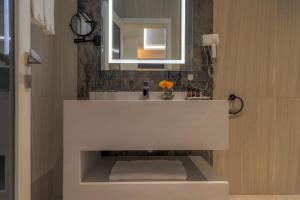 a bathroom with a white sink and a mirror at فندق ساس - SAS Hotel in Hafr Al Baten