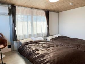 una camera con due letti accanto a una finestra di Izumo no Oyado Naka Araki - Vacation STAY 82773v a Izumo
