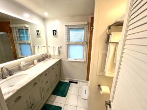 a bathroom with a sink and a mirror at Mar Bella Boutique Hotel in Rehoboth Beach