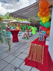 a patio with a table with drinks and balloons at Amazon Villas in Soufrière