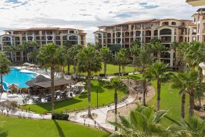 an aerial view of a resort with a pool and palm trees at Paraiso del Mar Condominiums in Misiones de La Paz