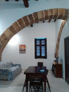 a living room with a table and a couch at Residence Marsala Antica in Marsala