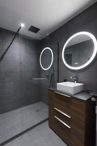a bathroom with a sink and a mirror at Antibes Calm: Your Coastal Haven in Antibes