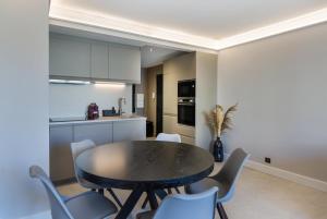 a kitchen and dining room with a table and chairs at Antibes Calm: Your Coastal Haven in Antibes