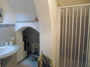 a bathroom with a sink and a toilet and a door at Residence Marsala Antica in Marsala