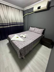 a small bedroom with a bed with a notebook on it at URAZ Apart in Bursa