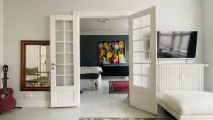 a room with a door open to a bedroom at ApartmentInCopenhagen Apartment 1599 in Hellerup