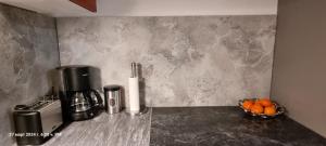 a counter top with a coffee maker and a bowl of oranges at Studio Apartment Nähe S-Bahn in Oberesslingen