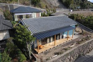 einen Blick über ein Haus mit blauem Dach in der Unterkunft iko terrace - Vacation STAY 03308v in Kagoshima