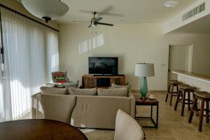 a living room with a couch and a flat screen tv at Paraiso del Mar Condominiums in Misiones de La Paz