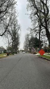 an empty street with a sign on the side of the road at North Pomona Home Near Claremont Colleges in Pomona