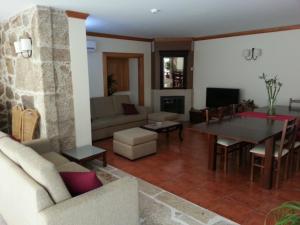 a living room with a couch and a table at Quinta da Cardal in Vila Verde